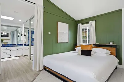 a bedroom with green walls and a large bed at 4BR Family Retreat with Hot Tub Games & Fire Pit in Chula Vista