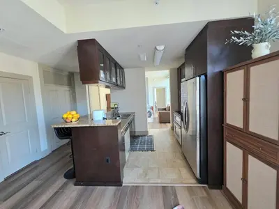 a large kitchen with a stainless steel refrigerator at Downtown Beautiful 3-bedroom Apartment Steps to Convention Center, Petco Park! in San Diego