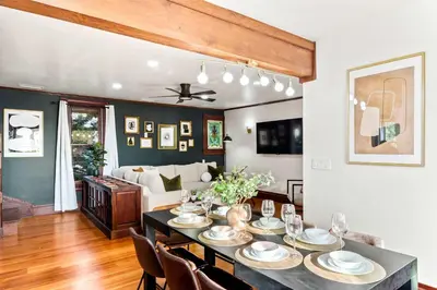 a dining room and living room with a table and chairs at Top 2 Floors Historic Mansion Game Room City Views in San Diego