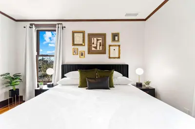 a white bedroom with a large white bed at Top 2 Floors Historic Mansion Game Room City Views in San Diego