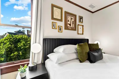 a bedroom with a white bed with a window at Top 2 Floors Historic Mansion Game Room City Views in San Diego