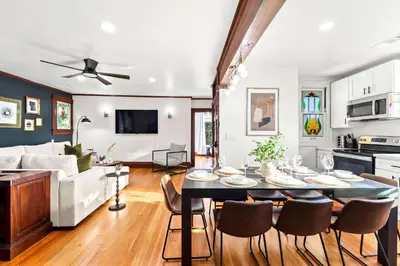 a kitchen and living room with a table and chairs at Top 2 Floors Historic Mansion Game Room City Views in San Diego