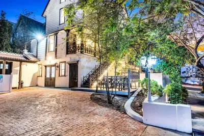 a house with a brick driveway in front of it at Iconic Mansion with Hot Tub GYM Arcade and Parking in San Diego