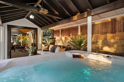 a hot tub in the middle of a living room at Iconic Mansion with Hot Tub GYM Arcade and Parking in San Diego