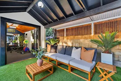 a living room with a couch and a table at Iconic Mansion with Hot Tub GYM Arcade and Parking in San Diego