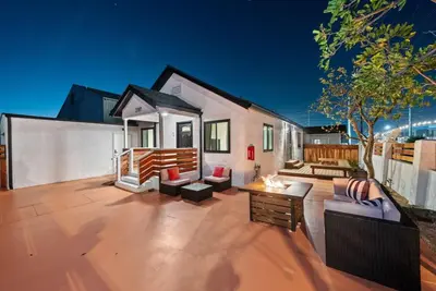 a house with a large patio with a table at Barrio Bungalow by Coastline Vacation Rentals in San Diego