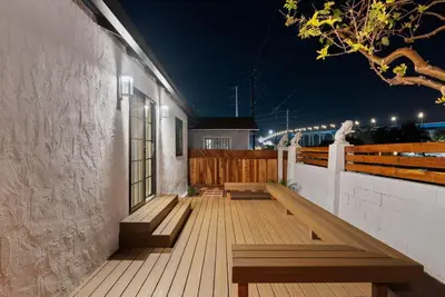 a wooden deck with benches on a house at night at Barrio Bungalow by Coastline Vacation Rentals in San Diego