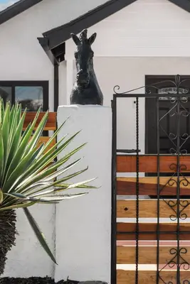 a statue of a horse head on a wall next to a house at Barrio Bungalow by Coastline Vacation Rentals in San Diego