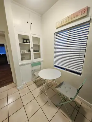 a table and chairs in a room with a window at The Seabreeze by Coastline Vacation Rentals in San Diego