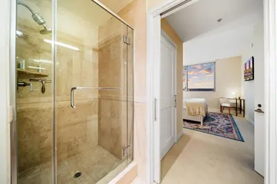 a bathroom with a shower with a glass door at Electra Building 2bed - Views Pool Sauna Spa in San Diego