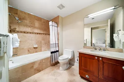 a bathroom with a toilet and a tub and a sink at Electra Building 2bed - Views Pool Sauna Spa in San Diego
