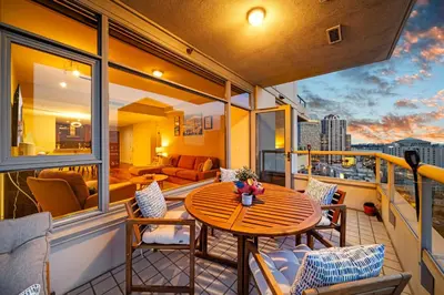 a balcony with a table and chairs and a couch at Electra Building 2bed - Views Pool Sauna Spa in San Diego