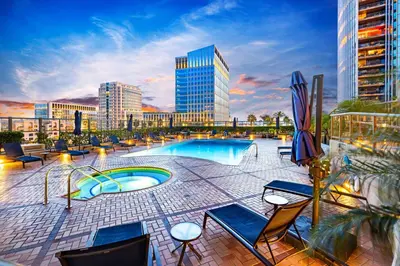 a swimming pool with chairs and a building at Electra Building 2bed - Views Pool Sauna Spa in San Diego