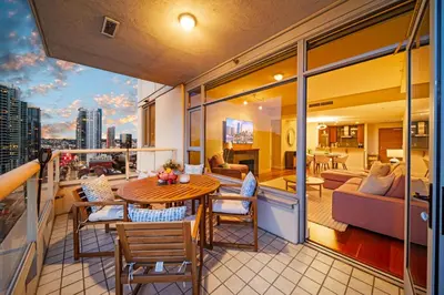 a balcony with a table and chairs and a living room at Electra Building 2bed - Views Pool Sauna Spa in San Diego