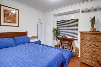 a bedroom with a blue bed and a desk at Casa Mellifora 3BR Golden Hill w Garage Parking in San Diego