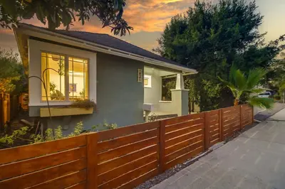 a house with a wooden fence in front of it at Casa Mellifora 3BR Golden Hill w Garage Parking in San Diego