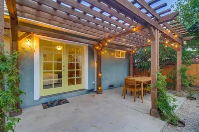 a patio with a wooden pergola and a wooden table at Casa Mellifora 3BR Golden Hill w Garage Parking in San Diego