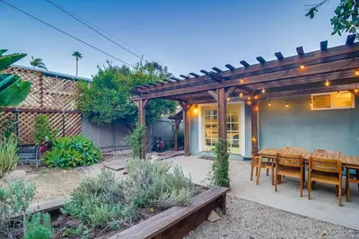 a patio with a wooden pergola and a table and chairs at Casa Mellifora 3BR Golden Hill w Garage Parking in San Diego