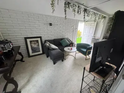 a living room with a couch and a tv at My Cozy Place in Mission Viejo