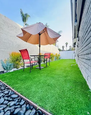a patio with a table and two chairs and an umbrella at My Cozy Place in Mission Viejo