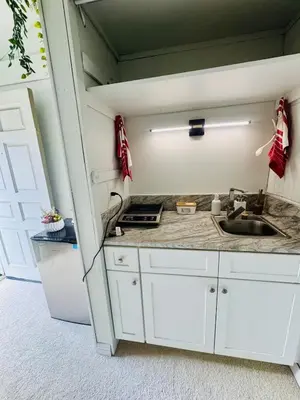 a kitchen with white cabinets and a sink at My Cozy Place in Mission Viejo