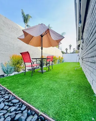 a patio with a table and chairs and an umbrella at My Cozy Place in Mission Viejo