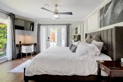 a bedroom with a large white bed and a desk at O-side Oasis in Oceanside