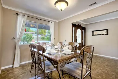 a dining room with a table and chairs and a window at O-side Oasis in Oceanside