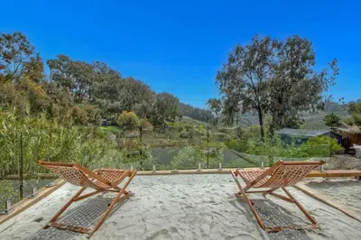 two chairs on a patio with a view of a river at O-side Oasis in Oceanside