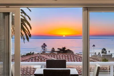 a view of a sunset from a room with a window at Golden Hour by Coastline Vacation Rentals in Encinitas