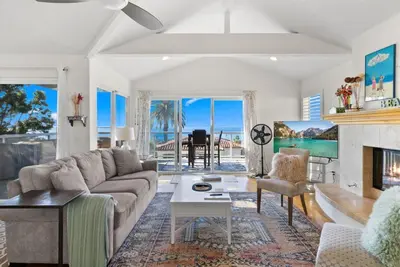 a living room with a couch and a fireplace at Golden Hour by Coastline Vacation Rentals in Encinitas