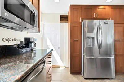 a kitchen with a stainless steel refrigerator at Blue Tide by Coastline Vacation Rentals in San Diego
