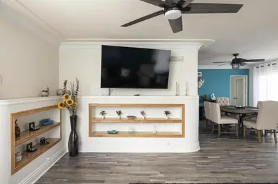 a living room with a flat screen tv on a wall at Blue Tide by Coastline Vacation Rentals in San Diego