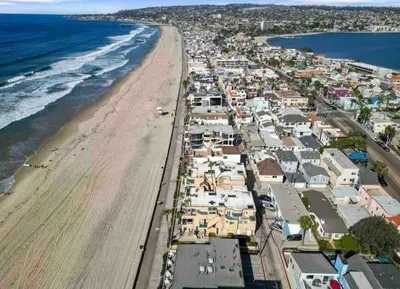 an aerial view of a beach with houses and the ocean at Blue Tide by Coastline Vacation Rentals in San Diego