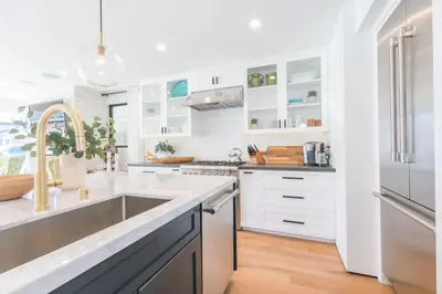 a kitchen with white cabinets and a sink at 6Br Tri-Level W Ac, Ocean Views, Rooftop Deck And Hot Tub By Beachview Rentals in Newport Beach