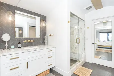 a white bathroom with a sink and a shower at 6Br Tri-Level W Ac, Ocean Views, Rooftop Deck And Hot Tub By Beachview Rentals in Newport Beach