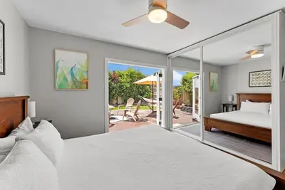 a bedroom with a bed and a sliding glass door at Serena Encinitas by Coastline Vacation Rentals in Encinitas