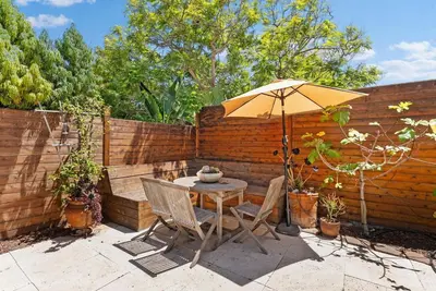 a patio with a table and an umbrella at Serena Encinitas by Coastline Vacation Rentals in Encinitas