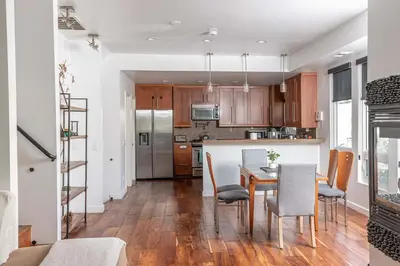 a kitchen and dining room with a table and chairs at Chic SD Basecamp - Walk to Downtown in San Diego