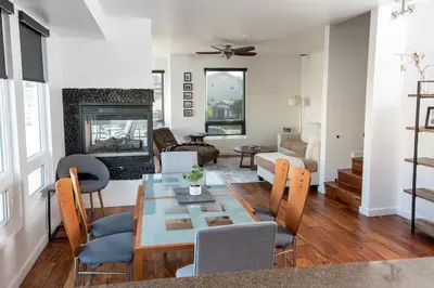 a living room with a table and chairs and a fireplace at Chic SD Basecamp - Walk to Downtown in San Diego