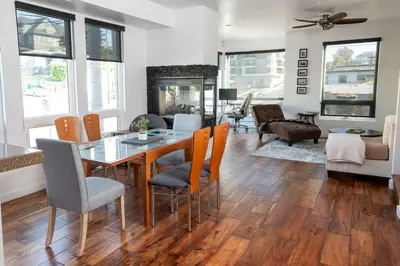 a dining room and living room with a table and chairs at Chic Downtown SD Hub for Families & Friends in San Diego