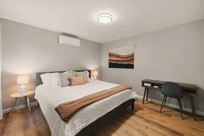 a bedroom with a bed and a desk in it at The Artist's Loft by Coastline Vacation Rentals in San Diego
