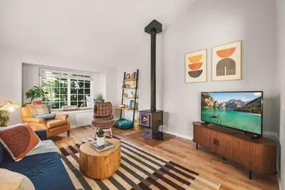 a living room with a flat screen tv and a couch at The Artist's Loft by Coastline Vacation Rentals in San Diego