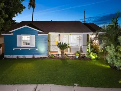 a blue house with a lawn in front of it at The Mosaic by Coastline Vacation Rentals in San Diego