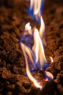a close up of a fire on some rocks at The Mosaic by Coastline Vacation Rentals in San Diego
