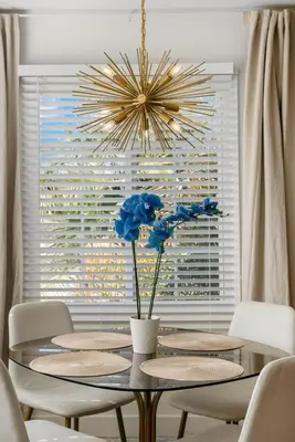 a dining room with a table and a chandelier at The Mosaic by Coastline Vacation Rentals in San Diego