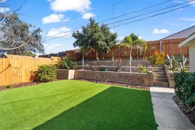 a garden with a lawn and a fountain at The Mosaic by Coastline Vacation Rentals in San Diego