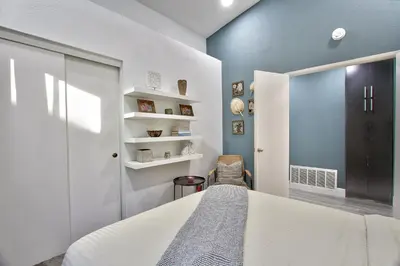 a bedroom with a white bed and a blue wall at Modern Design Temecula House-30 in Temecula