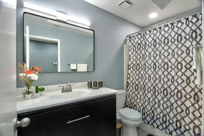 a bathroom with a sink and a toilet and a mirror at Modern Design Temecula House-30 in Temecula