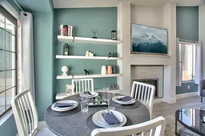 a dining room with a table and chairs and a fireplace at Modern Design Temecula House-30 in Temecula